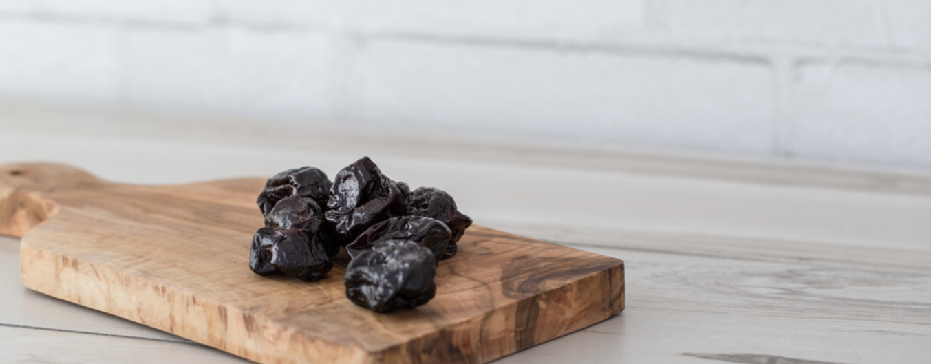 prunes placed on a wooden block